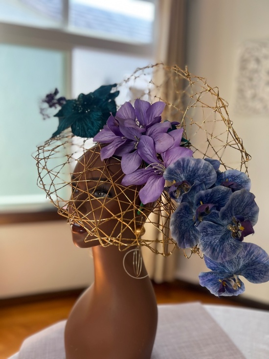 Green teal, purple flowers on a gold woven base fascinator